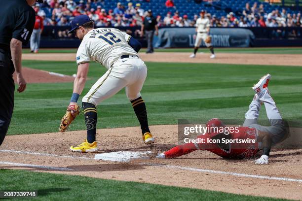 Los Angeles Angels center fielder Aaron Hicks drives back to first base during the MLB spring training baseball game between the Los Angeles Angels...