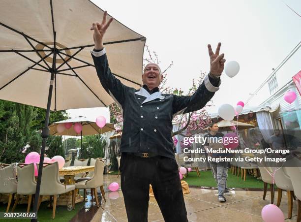 Chef Bruno Serato's stands out in the rain as he celebrates serving his 10 millionth meal to Southern California's needy children at the Anaheim...