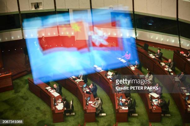 View of the Legislative Council chamber with China and Hong Kong flags reflected on the window as the 2nd reading of the Article 23 security law...