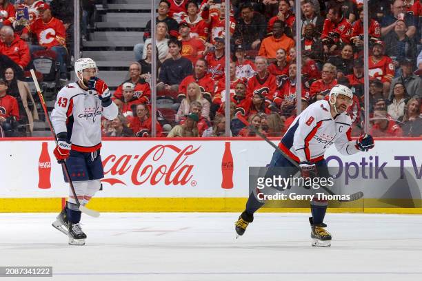 Alex Ovechkin and Tom Wilson of the Washington Capitals celebrate on ice after a goal against the Calgary Flames at Scotiabank Saddledome on March...