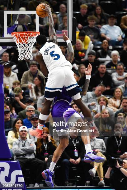 Anthony Edwards of the Minnesota Timberwolves dunks over John Collins of the Utah Jazz during the second half of a game at Delta Center on March 18,...