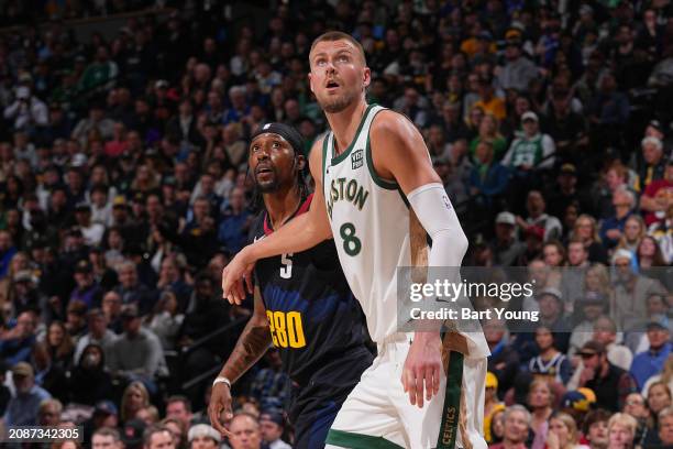 Kristaps Porzingis of the Boston Celtics battles for position with Kentavious Caldwell-Pope of the Denver Nuggets on March 7, 2024 at the Ball Arena...