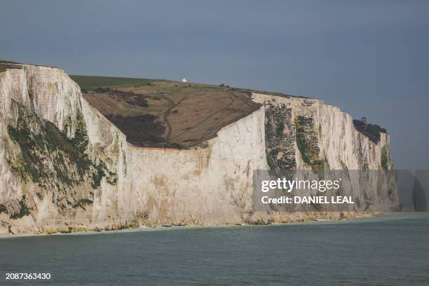 Photograph taken on March 14, 2024 shows the white cliffs of Dover pictured from the Hybrid Ferry ship P&O Liberte, docked in the port of Dover,...
