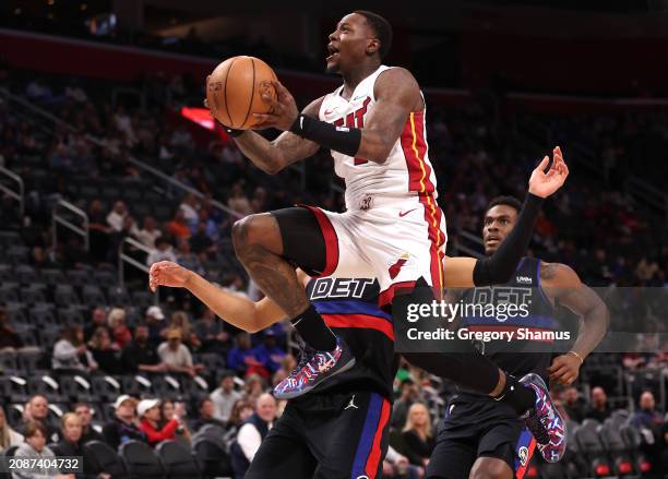 Terry Rozier of the Miami Heat drives to the basket past Cade Cunningham and Jalen Duren of the Detroit Pistons during the first half at Little...
