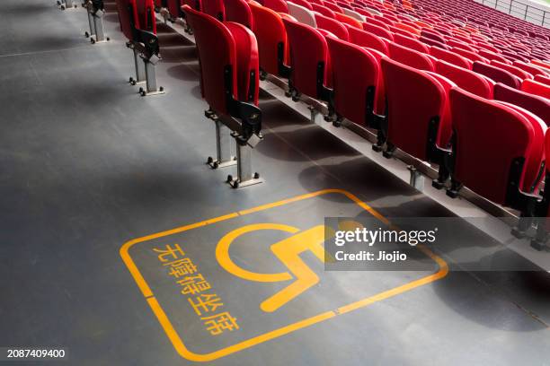 accessibility sign of stadium seats - stadion tafel stock-fotos und bilder