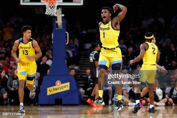 Kam Jones of the Marquette Golden Eagles reacts in the first half against the Providence Friars during the Semifinal round of the Big East Basketball...