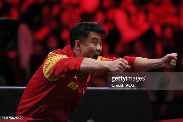 Chinese Men's Team head coach Wang Hao reacts as Liang Jingkun of China competes in the Men's Singles Quarterfinal match against Timo Boll of Germany...