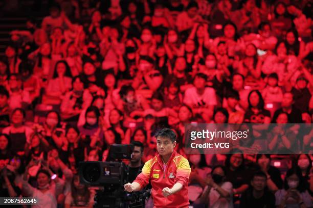 Chinese Men's Team head coach Wang Hao reacts as Liang Jingkun of China competes in the Men's Singles Quarterfinal match against Timo Boll of Germany...