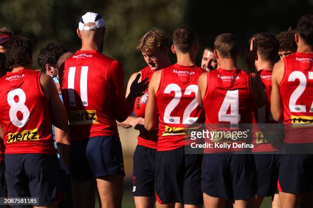 Demons players huddle during a Melbourne Demons AFL training session at Gosch's Paddock on March 16, 2024 in Melbourne, Australia.