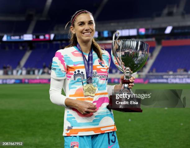 Alex Morgan of the San Diego Wave FC poses with her MVP trophy and the 2024 NWSL Challenge Cup at Red Bull Arena on March 15, 2024 in Harrison, New...