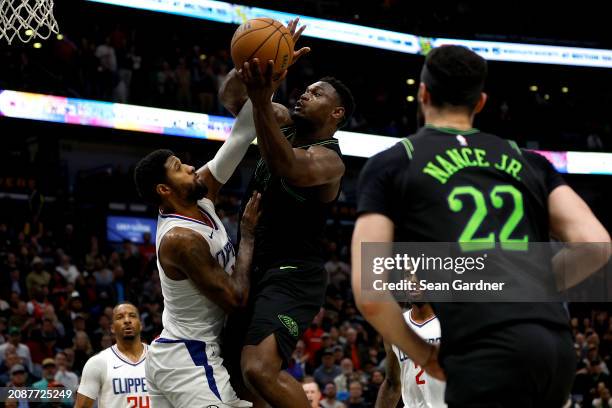 Zion Williamson of the New Orleans Pelicans shoots over Paul George of the LA Clippers during the fourth quarter of an NBA game at Smoothie King...