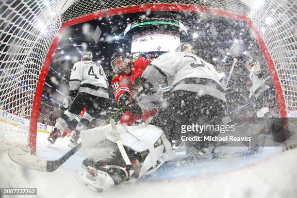 Connor Bedard of the Chicago Blackhawks and Cam Talbot of the Los Angeles Kings in action during the third period at the United Center on March 15,...