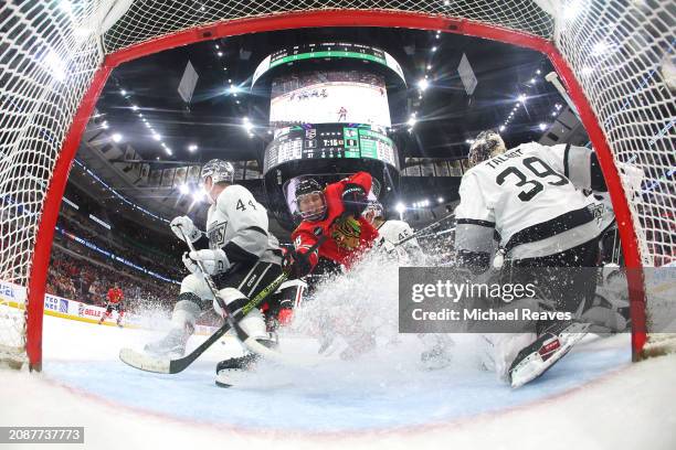 Connor Bedard of the Chicago Blackhawks and Cam Talbot of the Los Angeles Kings in action during the third period at the United Center on March 15,...