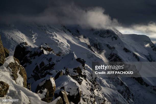 French mountaineer Charles Dubouloz walks on a ridge near the Glacier Du Geant around the Cosmiques hut, in the Mont Blanc Massif, around Chamonix,...