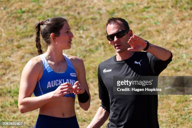 Eliza McCartney of Auckland talks to coach Scott Simpson during the 2024 New Zealand Athletics Championships at Newtown Park on March 16, 2024 in...