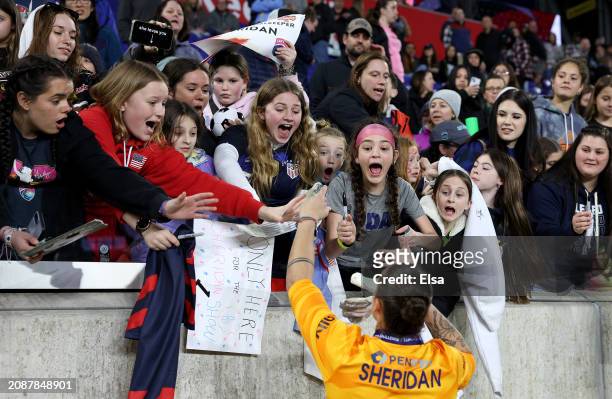 Fans react as Kailen Sheridan of the San Diego Wave FC greets fans after the 2024 NWSL Challenge Cup match at Red Bull Arena on March 15, 2024 in...