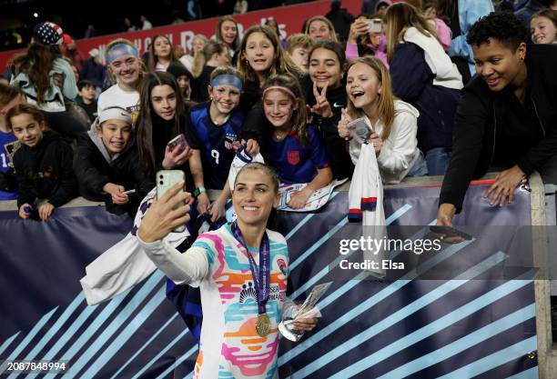 Alex Morgan of the San Diego Wave FC takes a selfie with fans after the 2024 NWSL Challenge Cup match at Red Bull Arena on March 15, 2024 in...