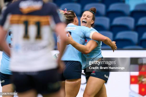 Maya Stewart of the Waratahs celebrates scoring a try with team mates during the round one Super Rugby Women's match between NSW Waratahs and ACT...