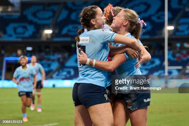 Tatum Bird of the Waratahs celebrates scoring a try with team mates during the round one Super Rugby Women's match between NSW Waratahs and ACT...