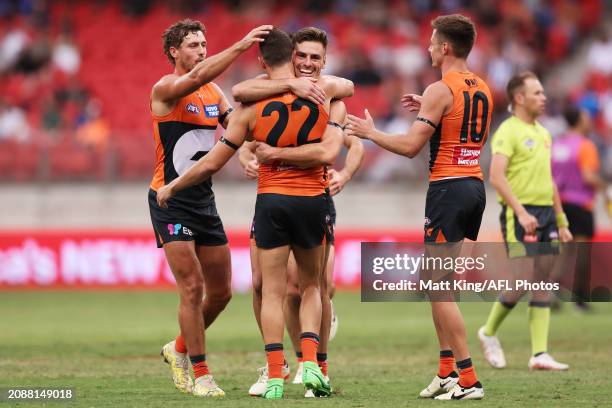 Josh Kelly of the Giants celebrates with team mates after kicking a goal during the round one AFL match between Greater Western Sydney Giants and...