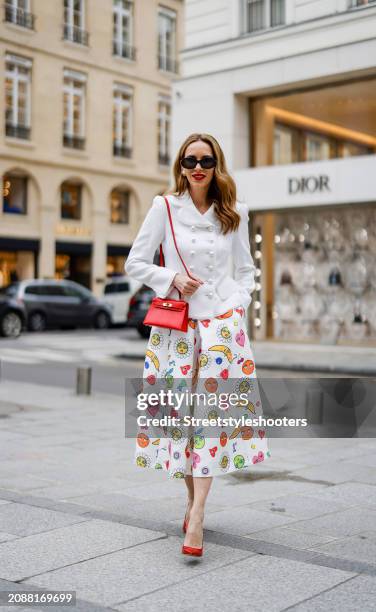 Alexandra Lapp is seen wearing a full look by Maison Common, a Hermes Kelly 25 bag in red, a red pumps by Gianvito Rossi and sunglasses by Celine on...