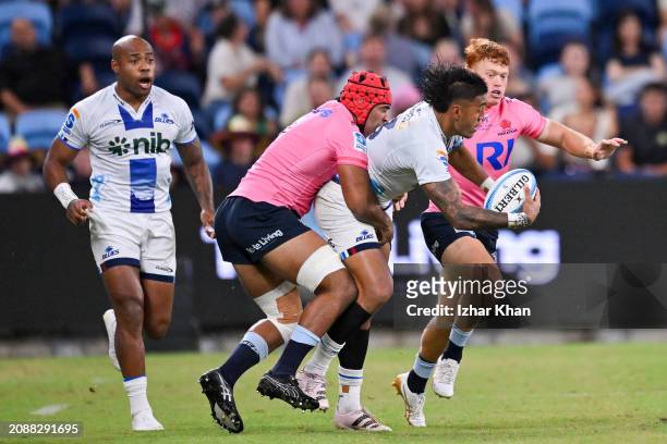 Rieko Ioane of the Blues is tackled by Langi Gleeson of the Waratahs during the round four Super Rugby Pacific match between NSW Waratahs and Blues...