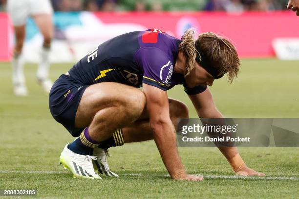 Ryan Papenhuyzen of the Storm reacts after colliding with Xavier Coates of the Storm during the round two NRL match between Melbourne Storm and New...