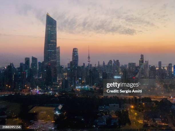 kuwait city skyline at sunset - kuwait stock pictures, royalty-free photos & images