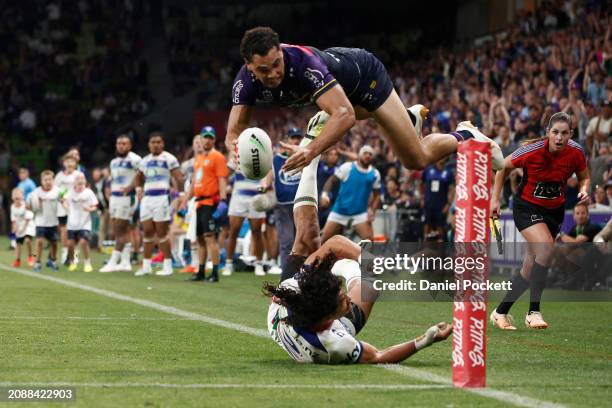 Xavier Coates of the Storm scores the match winning try during the round two NRL match between Melbourne Storm and New Zealand Warriors at AAMI Park,...