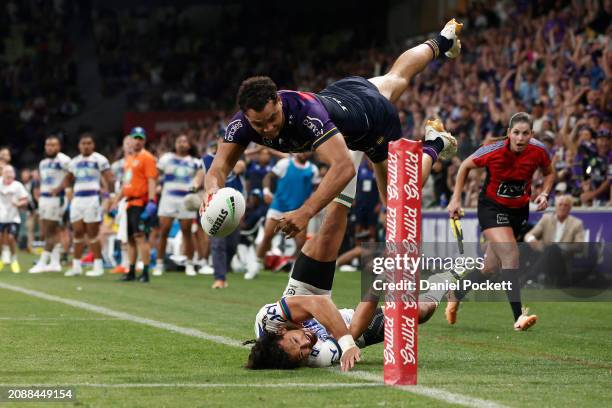 Xavier Coates of the Storm scores the match winning try during the round two NRL match between Melbourne Storm and New Zealand Warriors at AAMI Park,...