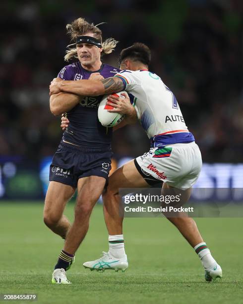 Ryan Papenhuyzen of the Storm is tackled by Shaun Johnson of the Warriors during the round two NRL match between Melbourne Storm and New Zealand...