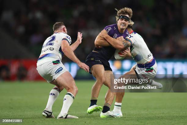 Ryan Papenhuyzen of the Storm is tackled by Shaun Johnson of the Warriors during the round two NRL match between Melbourne Storm and New Zealand...