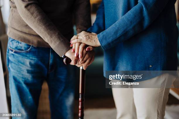 hands, walking stick or elderly person with disability, retirement closeup. senior care, cane or help with balance, support or parkinson disease with arthritis with health issue - parkinson krankheit stock-fotos und bilder