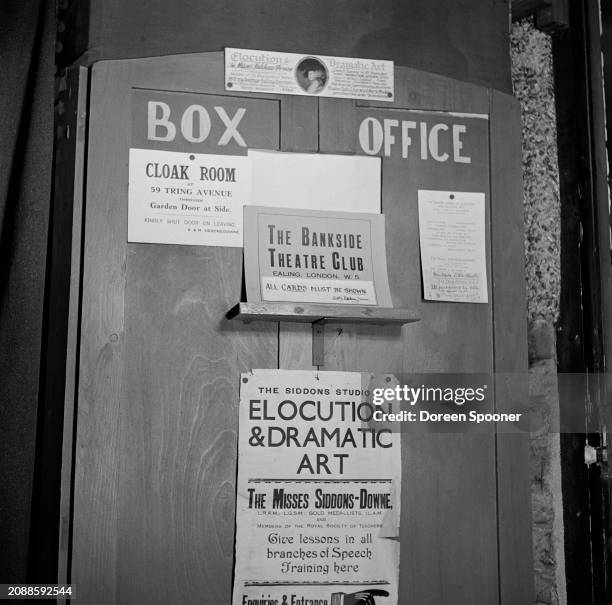 The box office of the Bankside Little Theatre, with signs for the 'Cloak Room', 'The Bankside Theatre Club', and 'The Siddons Studio of Elocution &...