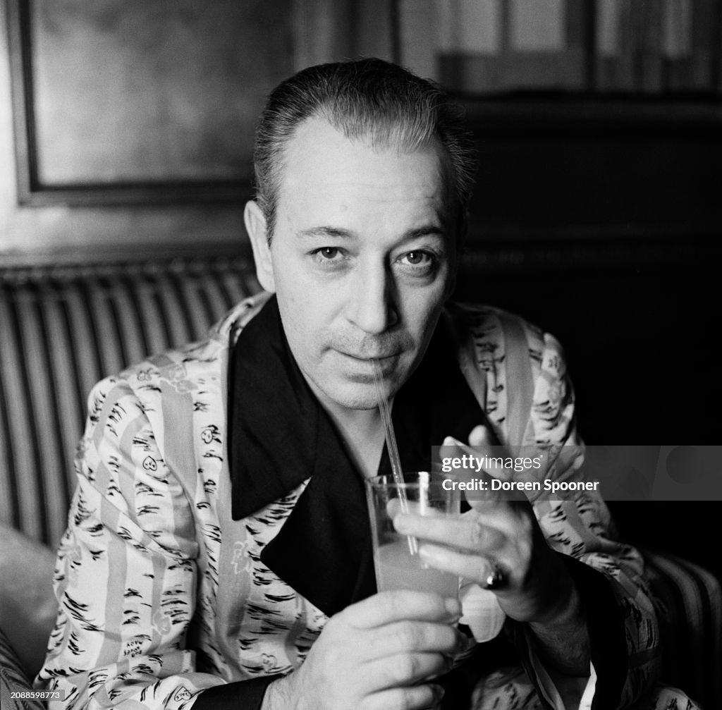 George Raft Dog American actor and dancer George Raft, wearing patterned loungewear ...