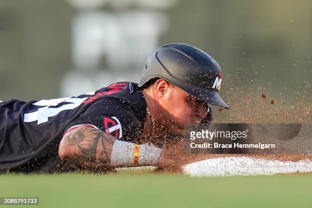 Jose Miranda of the Minnesota Twins slides during a spring training game against the Boston Red Sox on March 15, 2024 at the JetBlue Park in Fort...