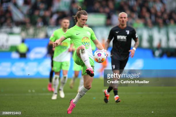 Patrick Wimmer of VfL Wolfsburg passes the ball during the Bundesliga match between VfL Wolfsburg and FC Augsburg at Volkswagen Arena on March 16,...