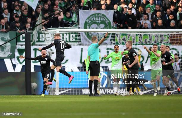 Kristijan Jakic of FC Augsburg celebrates scoring his team's second goal with teammate Ruben Vargas during the Bundesliga match between VfL Wolfsburg...