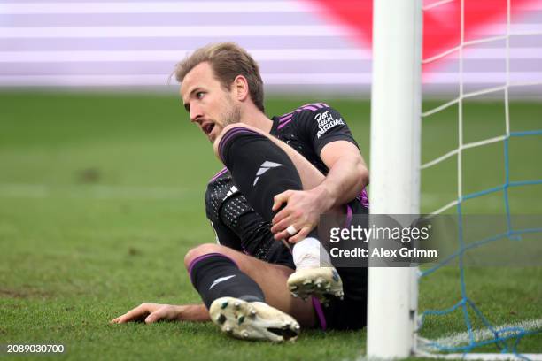 Harry Kane of Bayern Munich goes down with an injury and is later substituted during the Bundesliga match between SV Darmstadt 98 and FC Bayern...