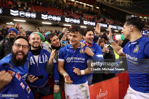 Lorenzo Pani and Juan Ignacio Brex of Italy celebrate with fans following the team's victory during the Guinness Six Nations 2024 match between Wales...