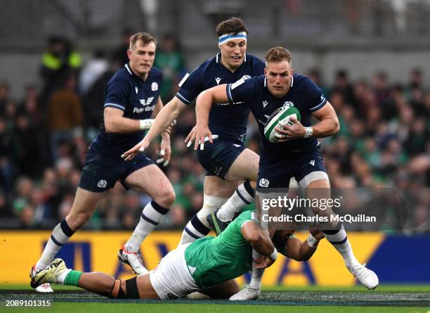 Duhan Van Der Merwe of Scotland is tackled by Bundee Aki of Ireland during the Guinness Six Nations 2024 match between Ireland and Scotland at Aviva...