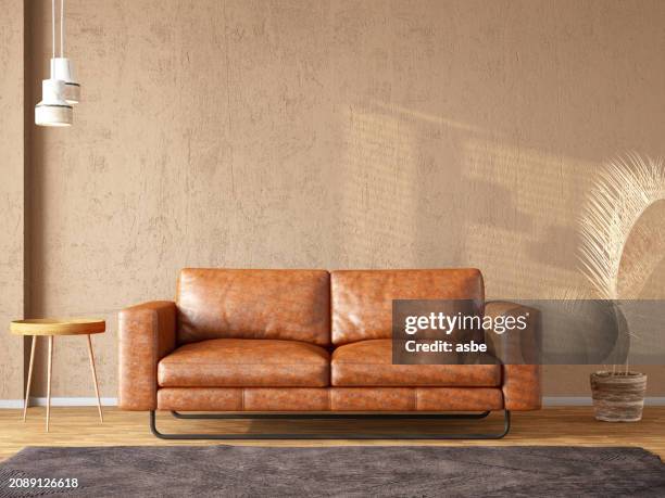 ledersofa mit einer leeren beigen wand für mockup - sofa stock-fotos und bilder