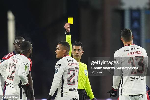 Referee Adonai Escobedo shows the yellow card to Ian Lawrence of LD Alajuelense during a Concacaf Champions Cup: Round of 16 game between LD...