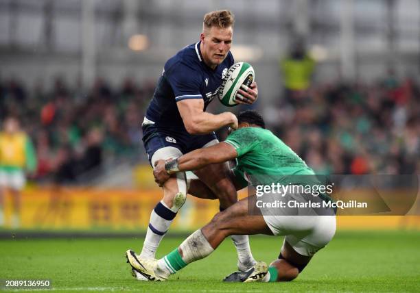 Duhan Van Der Merwe of Scotland is tackled by Bundee Aki of Ireland during the Guinness Six Nations 2024 match between Ireland and Scotland at Aviva...