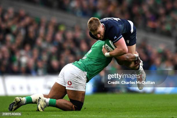 Kyle Steyn of Scotland is tackled by Bundee Aki of Ireland during the Guinness Six Nations 2024 match between Ireland and Scotland at Aviva Stadium...