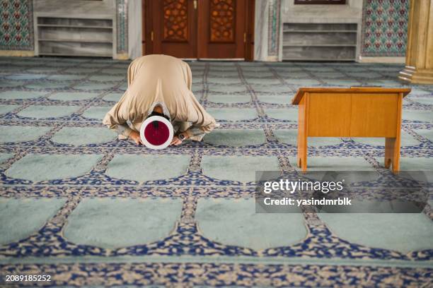 imam praying in the mosque prostrates - imam stock pictures, royalty-free photos & images