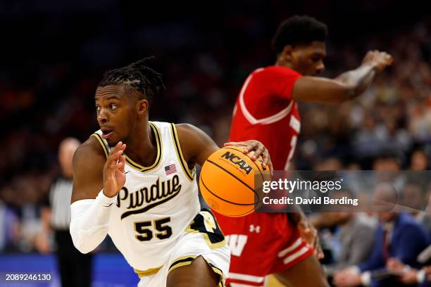 Lance Jones of the Purdue Boilermakers drives to the basket past AJ Storr of the Wisconsin Badgers in the first half of the Semifinals of the Big Ten...