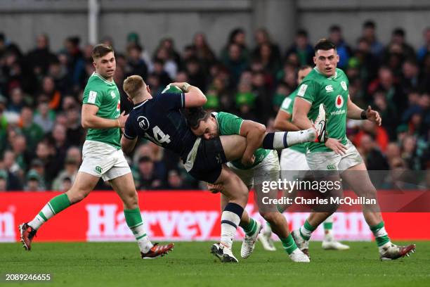 Kyle Steyn of Scotland is tackled by James Lowe of Ireland during the Guinness Six Nations 2024 match between Ireland and Scotland at Aviva Stadium...