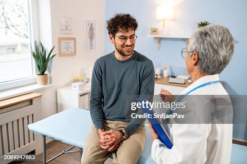 Male patient having an annual medical check-up with an senior Caucasian female doctor, at the ordination Male patient having an annual medical check-up with an senior Caucasian female doctor, at the ordination