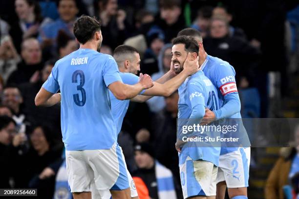 Bernardo Silva of Manchester City celebrates scoring his team's second goal with teammates during the Emirates FA Cup Quarter Final match between...